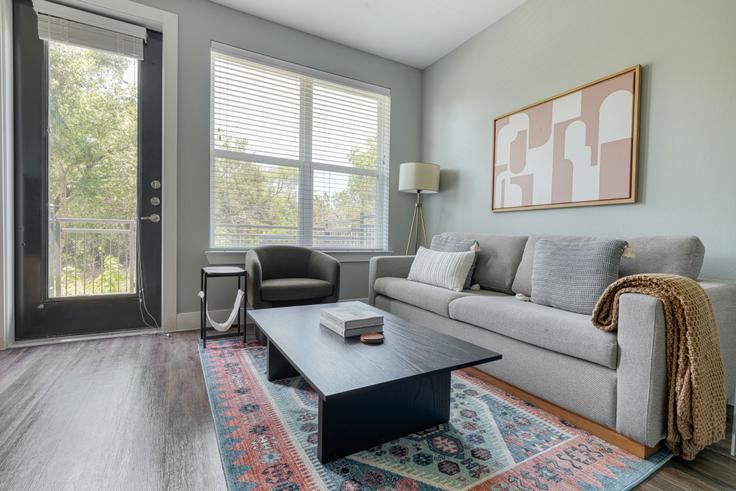 Elegantly designed living room with modern furnishings in an apartment at Camber Ranch in Lost Plains, Austin