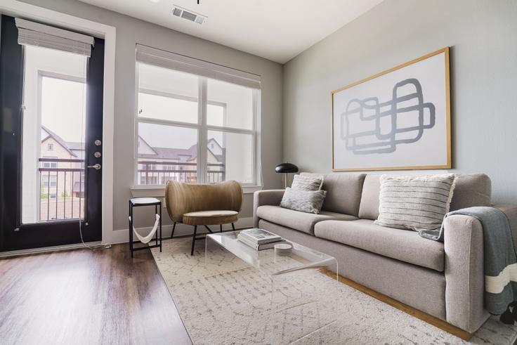 Elegantly designed living room with modern furnishings in an apartment at Camber Ranch in Lost Plains, Austin