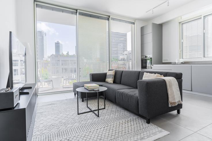 Elegantly designed living room with modern furnishings in an apartment at Mohaliver 31 in Nahalat Binyamin, Tel Aviv