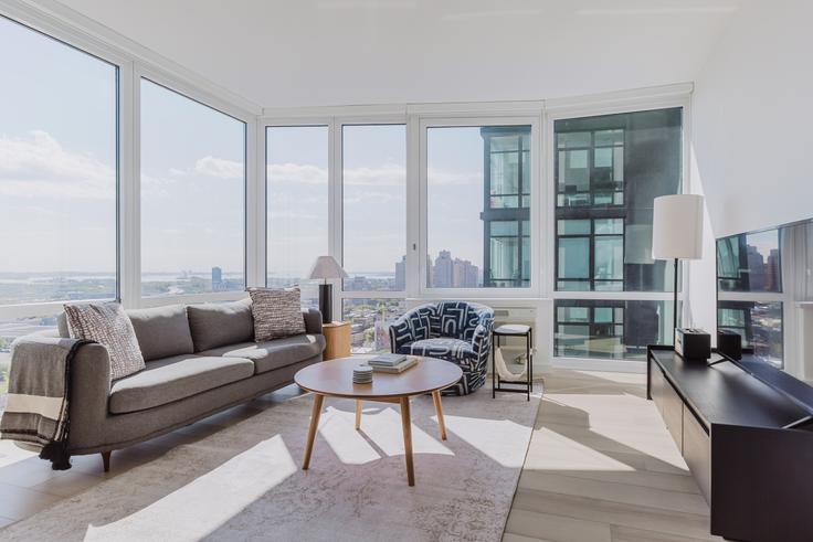 Elegantly designed living room with modern furnishings in an apartment at 425 Summit in Jersey City, New York