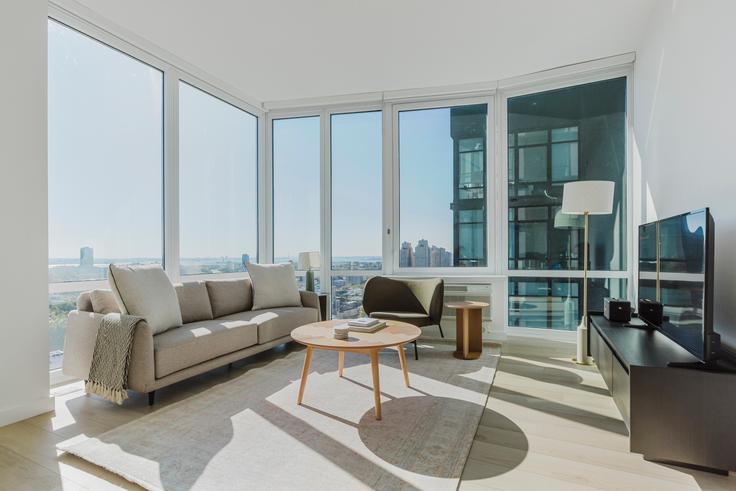 Elegantly designed living room with modern furnishings in an apartment at 425 Summit in Jersey City, New York