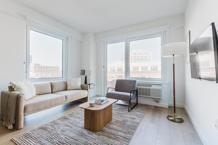 Sala de estar elegantemente projetada com móveis modernos em um apartamento no 425 Summit em Jersey City, Jersey City