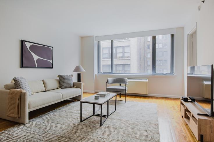 Elegantly designed living room with modern furnishings in an apartment at 21 Chelsea in Chelsea, New York