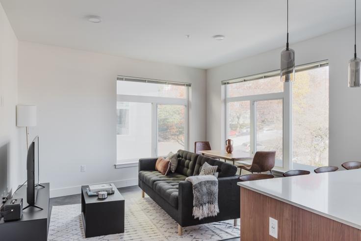 Elegantly designed living room with modern furnishings in an apartment at HiLite Apartments in First Hill, Seattle