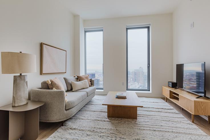 Elegantly designed living room with modern furnishings in an apartment at The Axel in Clinton Hill, New York