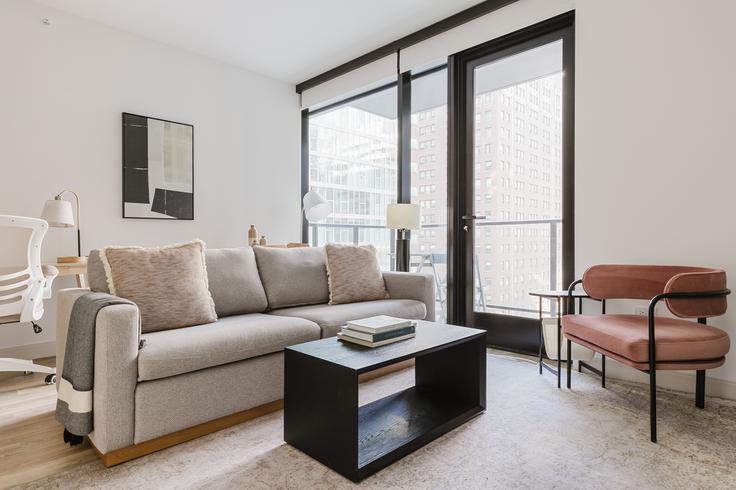 Elegantly designed living room with modern furnishings in an apartment at Saint Grand in Streeterville, Chicago