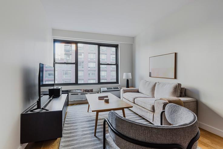 Elegantly designed living room with modern furnishings in an apartment at The Mayfair in Flatiron, New York