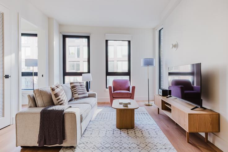 Elegantly designed living room with modern furnishings in an apartment at Casa Hope in Williamsburg, New York