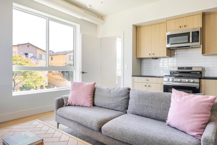 Elegantly designed living room with modern furnishings in an apartment at 611 N. Virgil in Los Angeles, Los Angeles