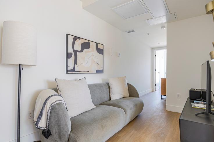 Elegantly designed living room with modern furnishings in an apartment at 611 N. Virgil in Los Angeles, Los Angeles