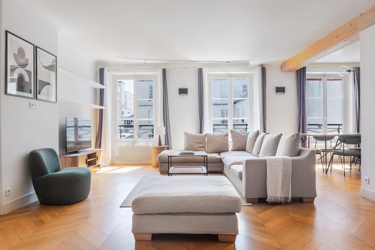 Elegantly designed living room with modern furnishings in an apartment at Faubourg Saint Denis 23 in 10th arrondissement, Paris Elegantly designed living room with modern furnishings in an apartment at Faubourg Saint Denis 23 in 10th arrondissement, Paris