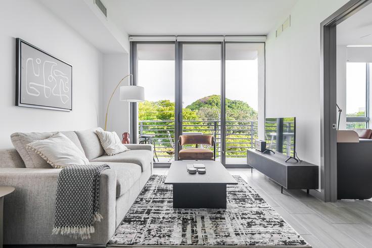 Elegantly designed living room with modern furnishings in an apartment at Adela at Mimo Bay in Miami, Miami
