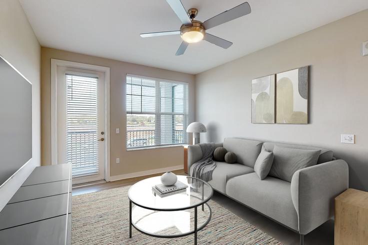 Elegantly designed living room with modern furnishings in an apartment at Cortland Nona in Lake Whippoorwill, Orlando