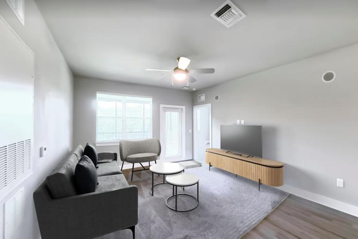 Elegante sala de estar con mobiliario moderno en un apartamento en Cortland Reunion en Four Corners, Four Corners