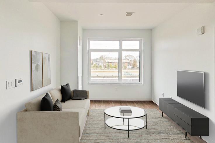 Elegante sala de estar con mobiliario moderno en un apartamento en The Indie en Boston, Boston