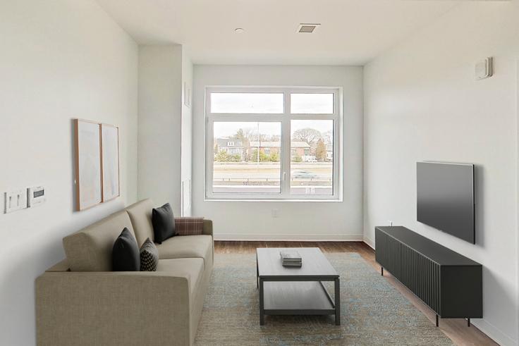 Elegante sala de estar con mobiliario moderno en un apartamento en The Indie en Boston, Boston